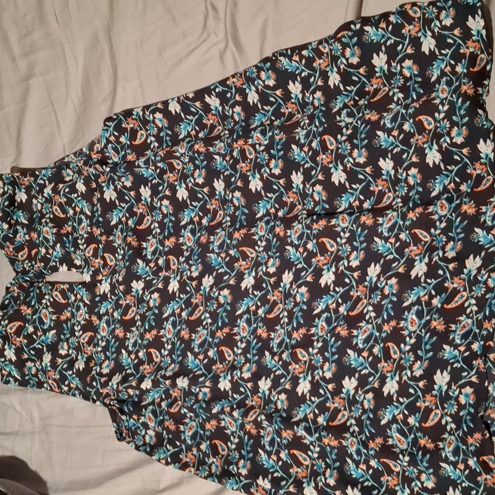 Beautiful sleeveless, small slits on each side as well as back, button closure.